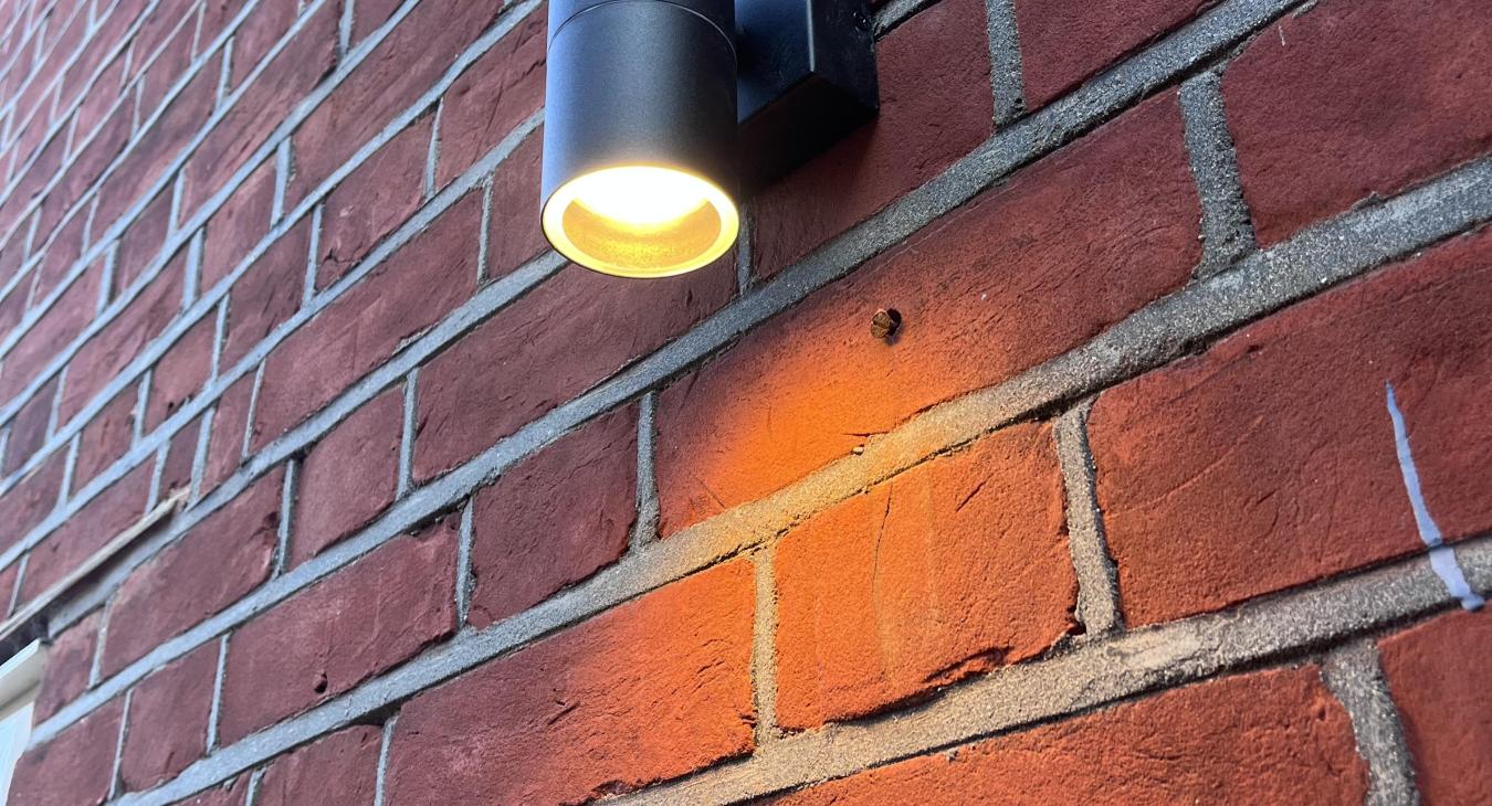 Black spotlight mounted outdoors 